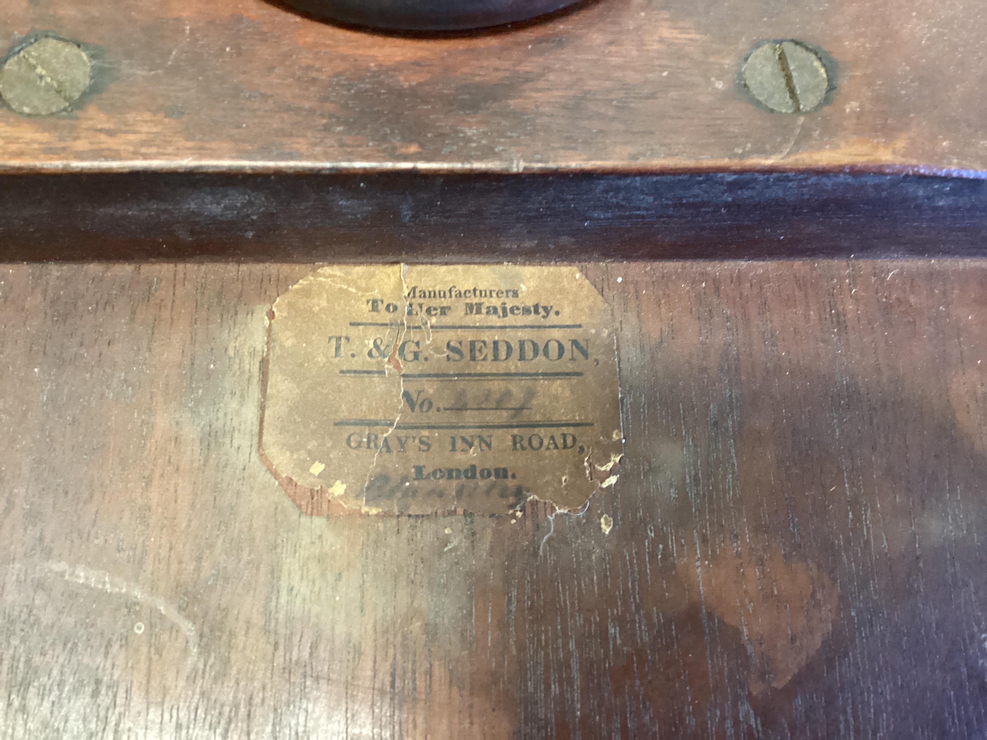 A Victorian circular banded mahogany tripod wine table, labelled T & G Seddon, diameter 46cm, height 74cm